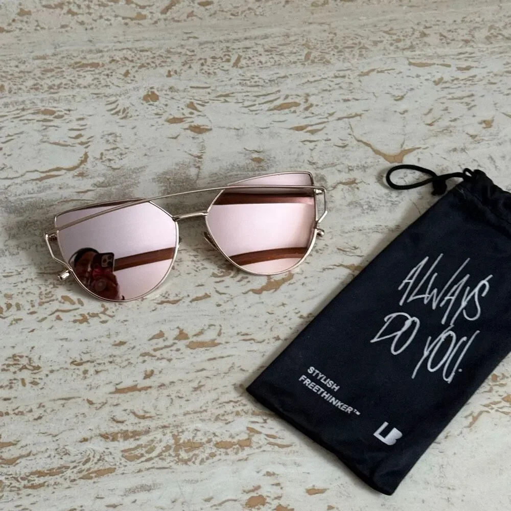 Rose gold wire frame cat eye aviator sunglasses with reflective pink lenses.